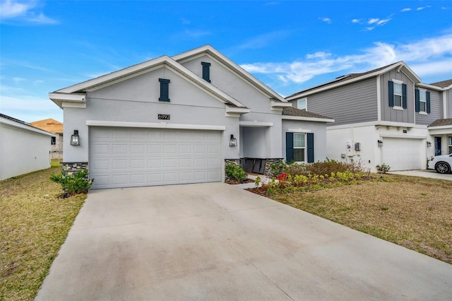 6992 Dilly Lake Ave, Groveland, FL 34736 - traditional-style home featuring concrete driveway, stucco siding, a front lawn, and a garage
