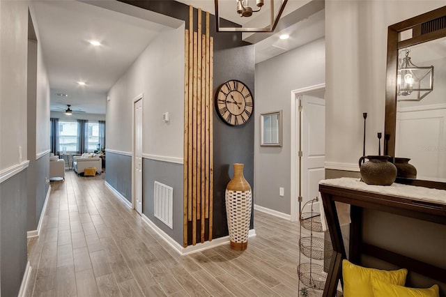 6992 Dilly Lake Ave, Groveland, FL 34736 - hall featuring wood finished floors, a chandelier, and recessed lighting