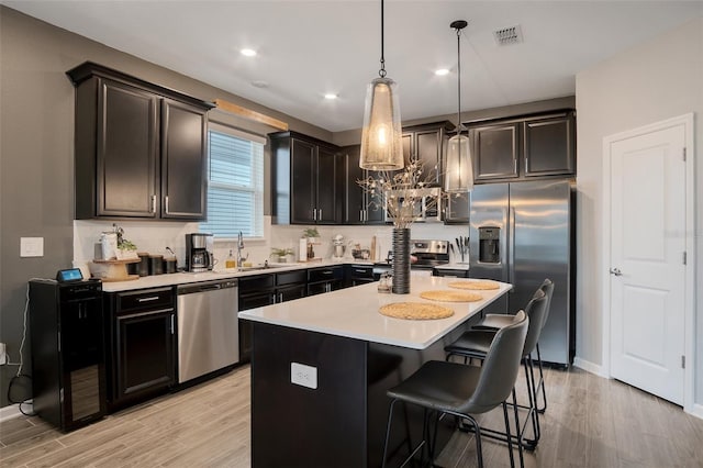 6992 Dilly Lake Ave, Groveland, FL 34736 - kitchen featuring stainless steel appliances, light wood finished floors, light countertops, a chandelier, and decorative light fixtures