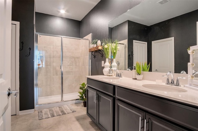 6992 Dilly Lake Ave, Groveland, FL 34736 - full bath with a shower stall, double vanity, tile patterned floors, and a textured wall
