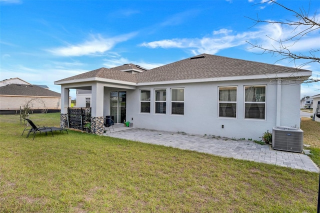6992 Dilly Lake Ave, Groveland, FL 34736 - back of house featuring roof with shingles, a patio area, stucco siding, and a lawn