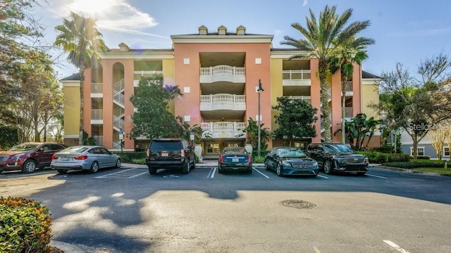 7650 Whisper Way Unit 304, Reunion, FL 34747 - view of building exterior featuring uncovered parking