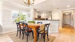 7650 Whisper Way Unit 304, Reunion, FL 34747 - dining space featuring a chandelier, light wood-style flooring, and recessed lighting