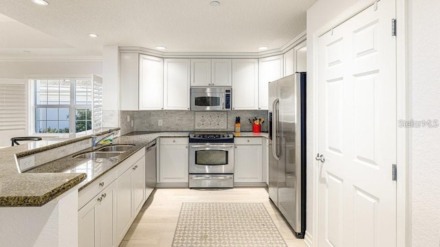 7650 Whisper Way Unit 304, Reunion, FL 34747 - kitchen featuring stainless steel appliances, ornamental molding, dark stone counters, a peninsula, and decorative backsplash