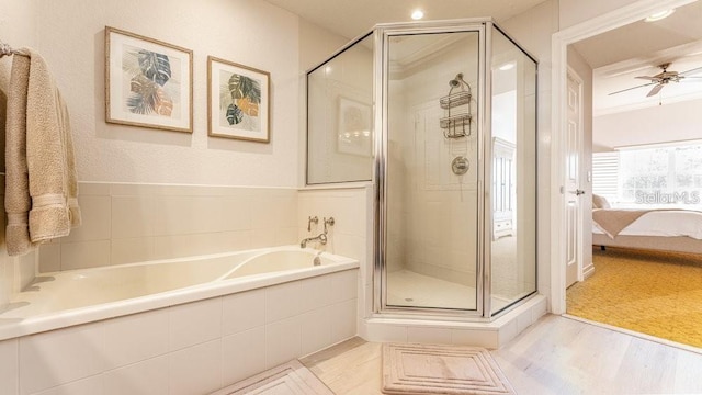 7650 Whisper Way Unit 304, Reunion, FL 34747 - ensuite bathroom featuring a shower stall, a bath, ceiling fan, and wood finished floors