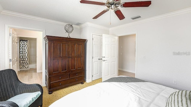 7650 Whisper Way Unit 304, Reunion, FL 34747 - bedroom featuring ornamental molding, ceiling fan, and light wood finished floors