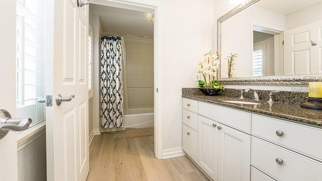 7650 Whisper Way Unit 304, Reunion, FL 34747 - full bathroom featuring wood finished floors, vanity, shower / bath combo, and plenty of natural light