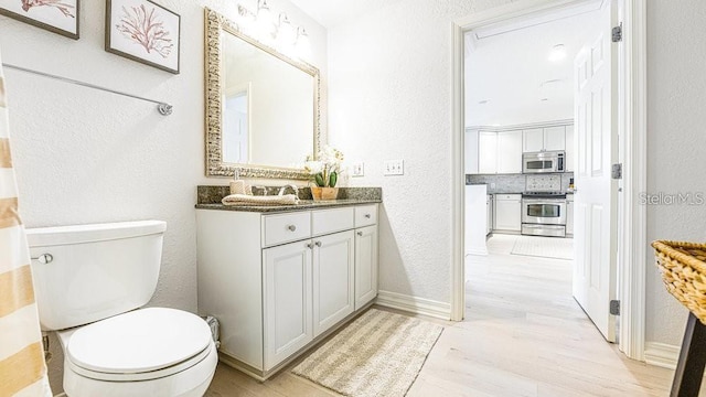 7650 Whisper Way Unit 304, Reunion, FL 34747 - bathroom featuring vanity, wood finished floors, and a textured wall