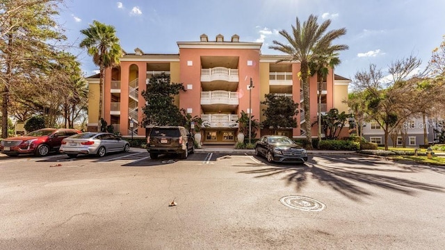7650 Whisper Way Unit 304, Reunion, FL 34747 - view of property featuring uncovered parking