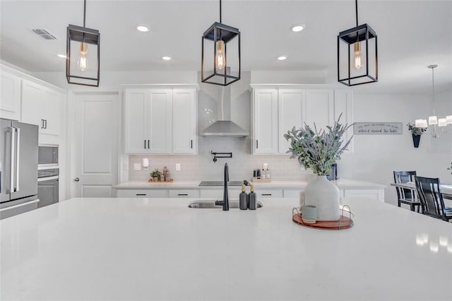 4477 Renly Ln, Clermont, FL 34711 - kitchen featuring decorative backsplash, wall chimney range hood, light countertops, white cabinets, and recessed lighting