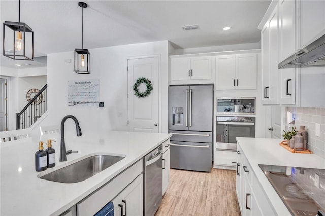 4477 Renly Ln, Clermont, FL 34711 - kitchen featuring stainless steel appliances, white cabinetry, extractor fan, light countertops, and recessed lighting