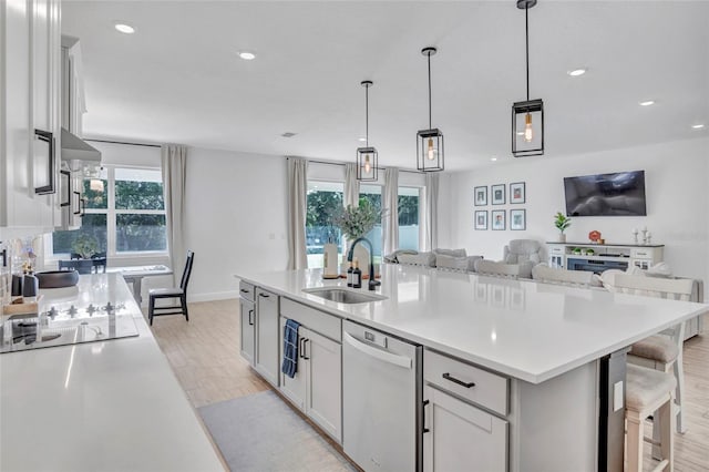 4477 Renly Ln, Clermont, FL 34711 - kitchen with dishwasher, open floor plan, a center island with sink, light countertops, and recessed lighting