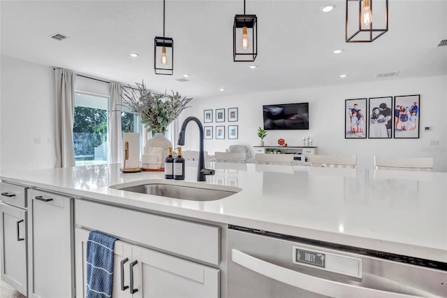 4477 Renly Ln, Clermont, FL 34711 - kitchen with stainless steel dishwasher, light countertops, white cabinetry, pendant lighting, and recessed lighting