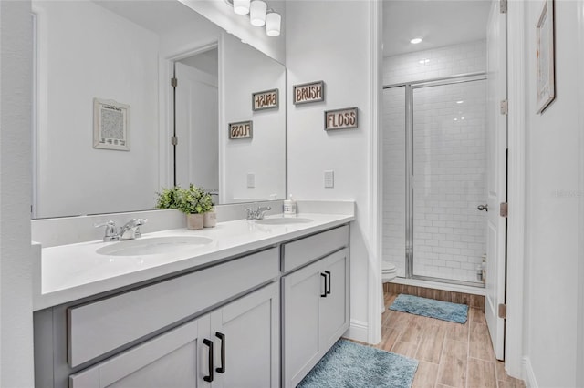 4477 Renly Ln, Clermont, FL 34711 - full bathroom featuring double vanity, a stall shower, and wood finished floors