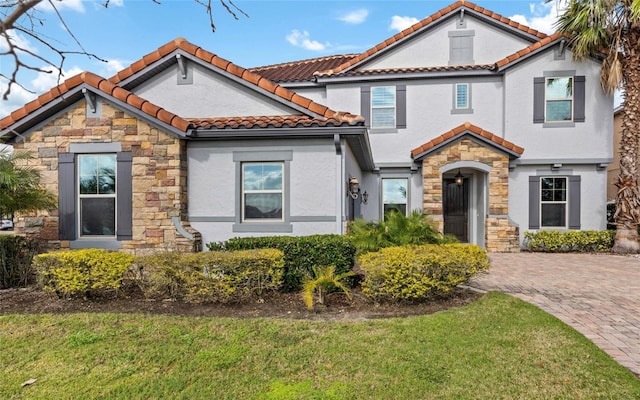 12023 Gold Creek Trl, Windermere, FL 34786 - mediterranean / spanish house with stone siding, a tile roof, stucco siding, and a front yard