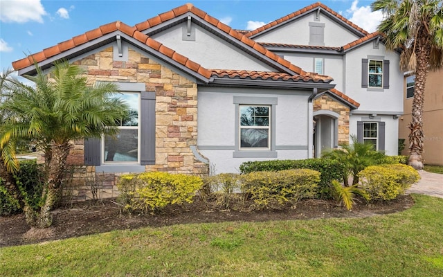 12023 Gold Creek Trl, Windermere, FL 34786 - mediterranean / spanish home featuring stone siding, stucco siding, a tile roof, and a front yard