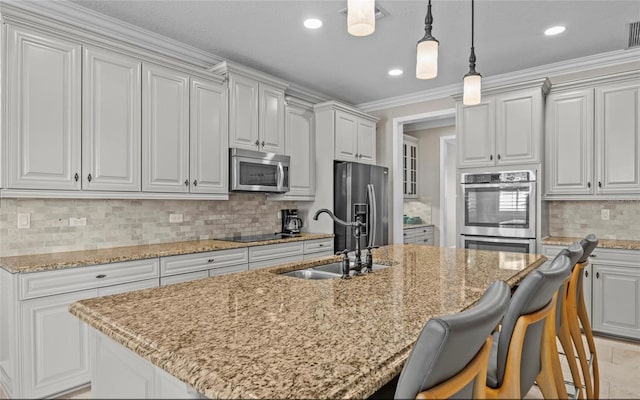 12023 Gold Creek Trl, Windermere, FL 34786 - kitchen with stainless steel appliances, a kitchen breakfast bar, decorative backsplash, an island with sink, and pendant lighting