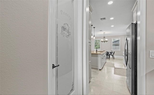 12023 Gold Creek Trl, Windermere, FL 34786 - hallway featuring ornamental molding, a chandelier, recessed lighting, and a textured wall