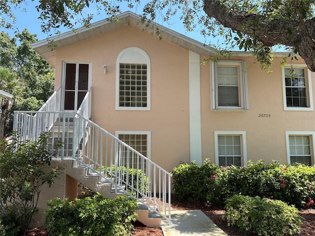 26735 Little John Ct Unit 27, Bonita Springs, FL 34135 - view of front of home featuring stucco siding and stairway