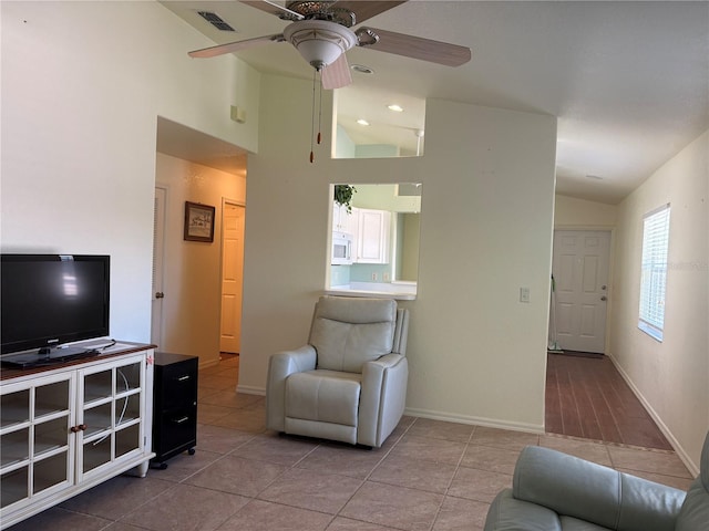 26735 Little John Ct Unit 27, Bonita Springs, FL 34135 - living room featuring vaulted ceiling, ceiling fan, and tile patterned floors