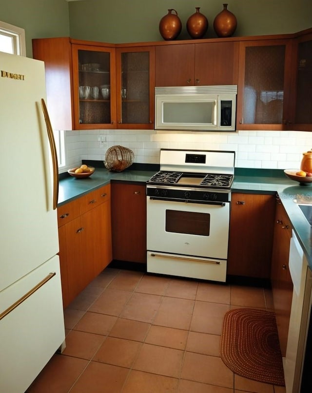 26735 Little John Ct Unit 27, Bonita Springs, FL 34135 - kitchen featuring white appliances, backsplash, and light tile patterned flooring