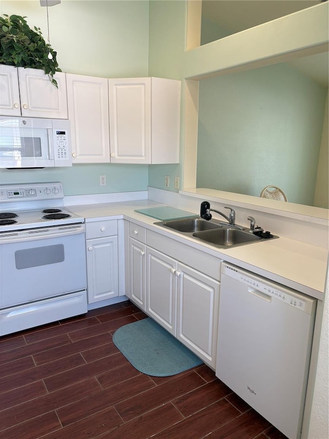 26735 Little John Ct Unit 27, Bonita Springs, FL 34135 - kitchen with white appliances, dark wood finished floors, light countertops, white cabinetry, and a peninsula