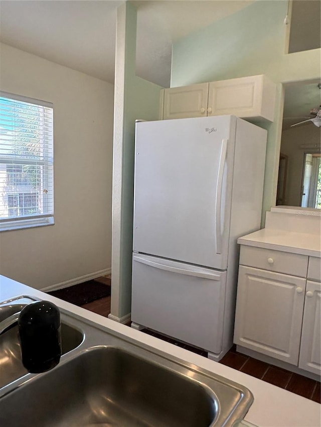 26735 Little John Ct Unit 27, Bonita Springs, FL 34135 - kitchen featuring freestanding refrigerator, white cabinets, light countertops, dark wood-style flooring, and a ceiling fan