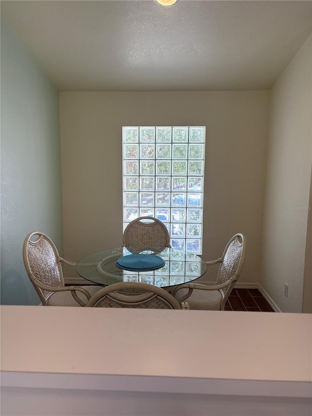 26735 Little John Ct Unit 27, Bonita Springs, FL 34135 - dining area with baseboards and dark tile patterned flooring