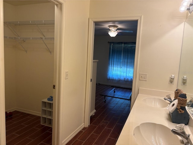 26735 Little John Ct Unit 27, Bonita Springs, FL 34135 - full bathroom featuring wood tiled floors, double vanity, ceiling fan, and a walk in closet