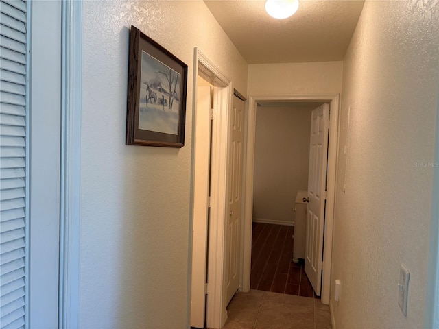 26735 Little John Ct Unit 27, Bonita Springs, FL 34135 - hallway featuring a textured wall and tile patterned flooring