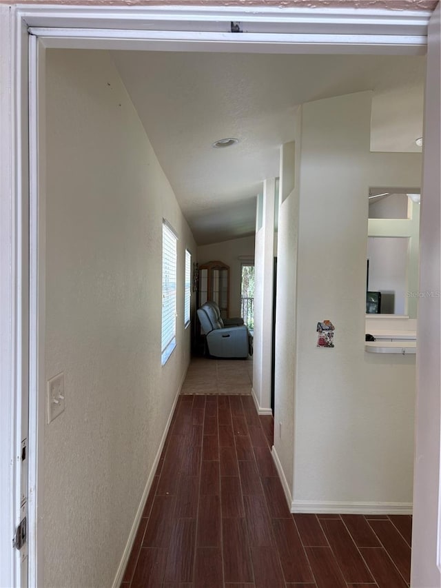 26735 Little John Ct Unit 27, Bonita Springs, FL 34135 - corridor with dark wood-type flooring, a textured wall, and vaulted ceiling