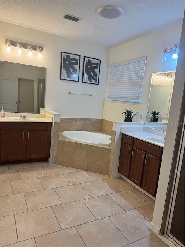 1954 Marabou Dr, Davenport, FL 33896 - bathroom with a garden tub, two vanities, and tile patterned floors