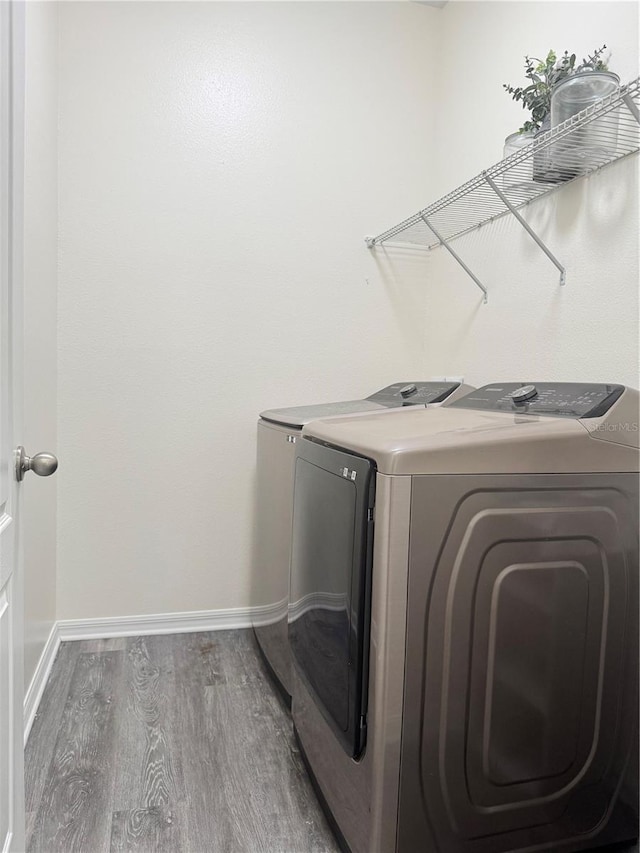 1954 Marabou Dr, Davenport, FL 33896 - laundry room featuring washing machine and clothes dryer and wood finished floors
