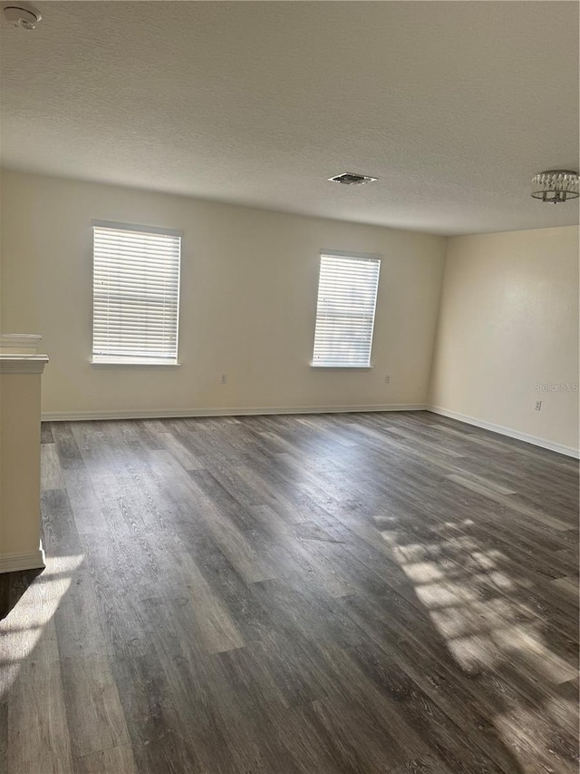 1954 Marabou Dr, Davenport, FL 33896 - empty room featuring dark wood finished floors, a textured ceiling, and a smoke detector