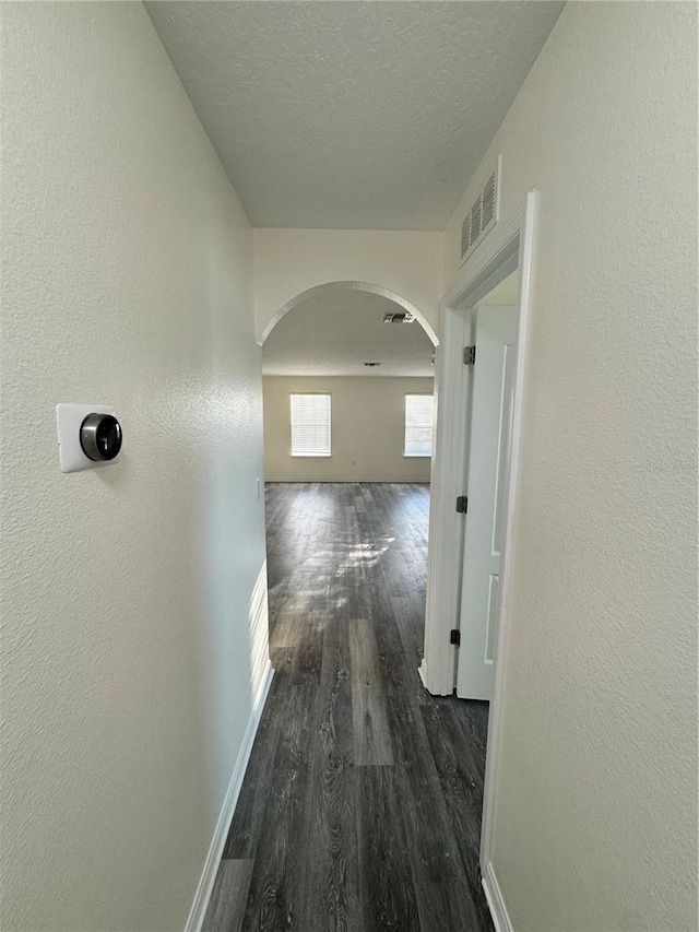 1954 Marabou Dr, Davenport, FL 33896 - corridor featuring arched walkways, dark wood-style floors, and a textured ceiling