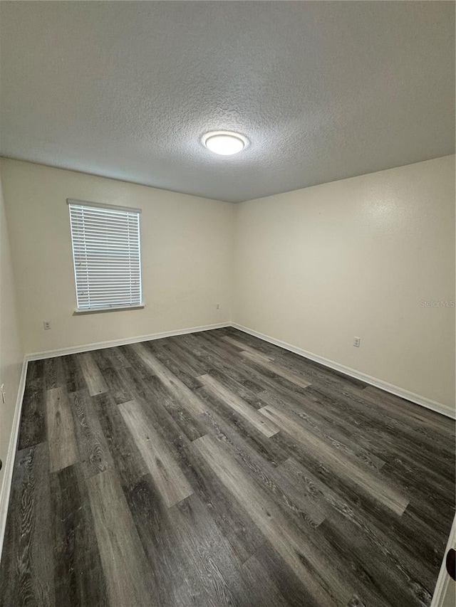 1954 Marabou Dr, Davenport, FL 33896 - empty room featuring dark wood-style floors and a textured ceiling