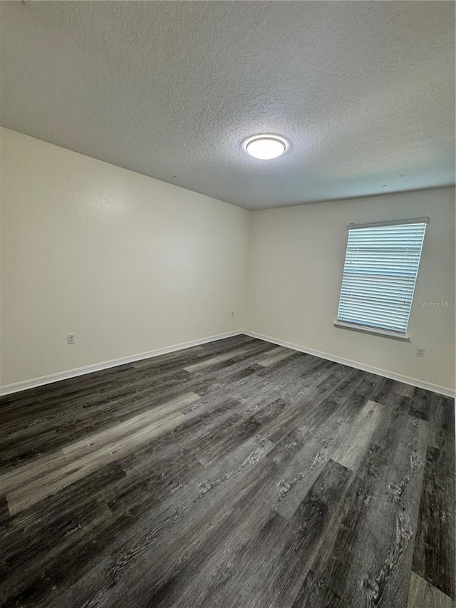 1954 Marabou Dr, Davenport, FL 33896 - unfurnished room with dark wood-type flooring and a textured ceiling