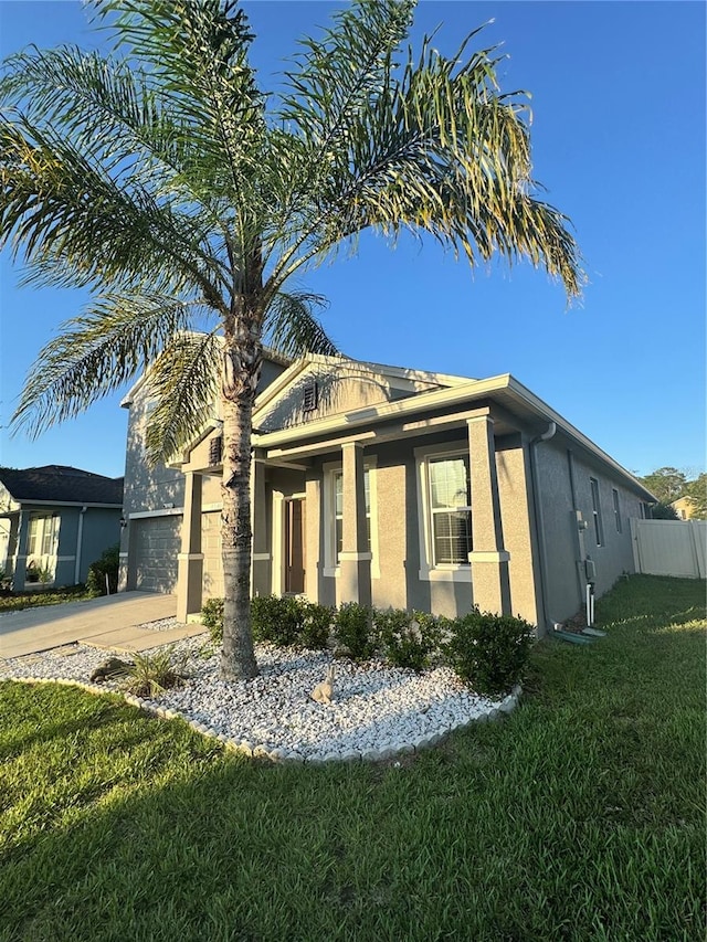 1954 Marabou Dr, Davenport, FL 33896 - view of front facade featuring stucco siding, driveway, and an attached garage