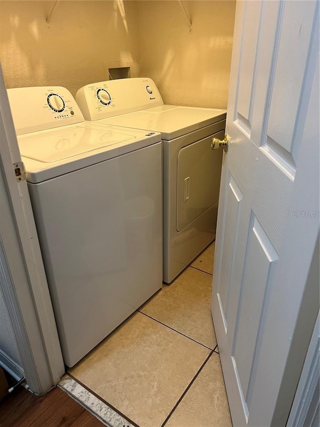 3593 Conroy Rd Unit 416, Orlando, FL 32839 - laundry area with independent washer and dryer and light tile patterned floors