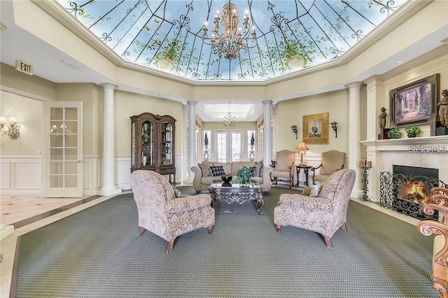 3593 Conroy Rd Unit 416, Orlando, FL 32839 - living room with decorative columns, carpet, a fireplace with flush hearth, a towering ceiling, and a chandelier