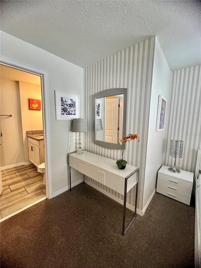 3191 Pequod Pl, Kissimmee, FL 34746 - hall with a textured ceiling, wood finished floors, carpet, and wallpapered walls