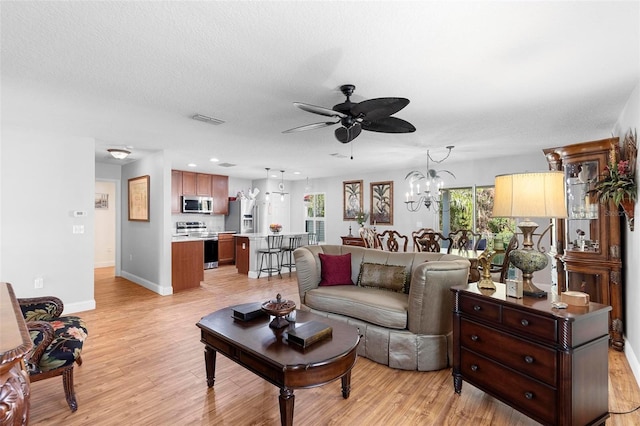 43 Pergola Pl, Ormond Beach, FL 32174 - living room with a ceiling fan, light wood-style floors, and a chandelier