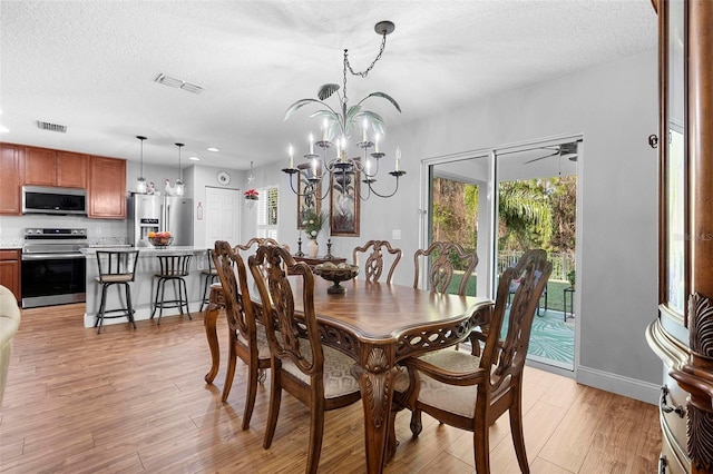 43 Pergola Pl, Ormond Beach, FL 32174 - dining area featuring plenty of natural light, light wood-style flooring, a textured ceiling, a chandelier, and recessed lighting