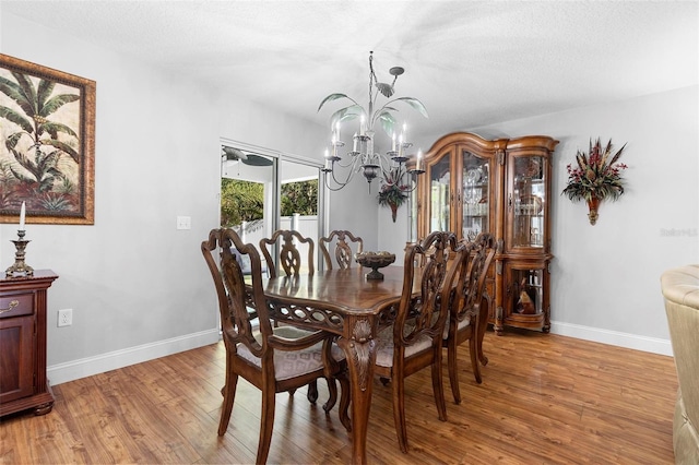 43 Pergola Pl, Ormond Beach, FL 32174 - dining space featuring a chandelier, light wood-type flooring, and a textured ceiling