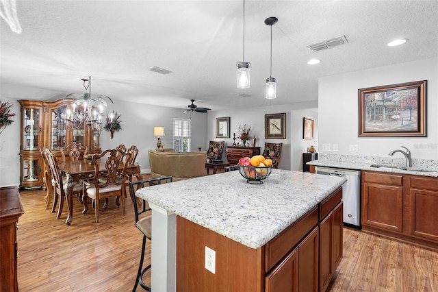 43 Pergola Pl, Ormond Beach, FL 32174 - kitchen featuring light wood finished floors, a kitchen island, stainless steel dishwasher, decorative light fixtures, and recessed lighting