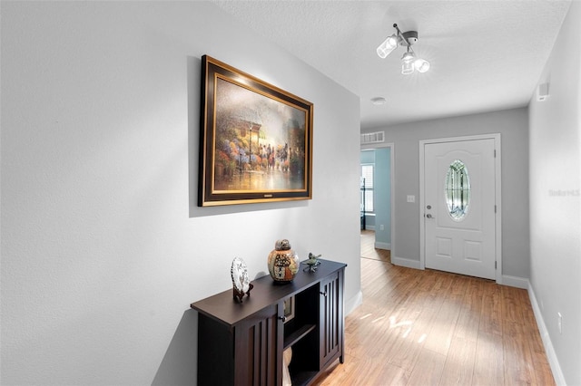 43 Pergola Pl, Ormond Beach, FL 32174 - foyer entrance with light wood-style floors and baseboards