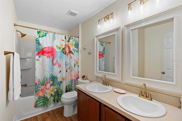 43 Pergola Pl, Ormond Beach, FL 32174 - full bathroom featuring shower / bath combo with shower curtain, double vanity, wood finished floors, and a textured ceiling