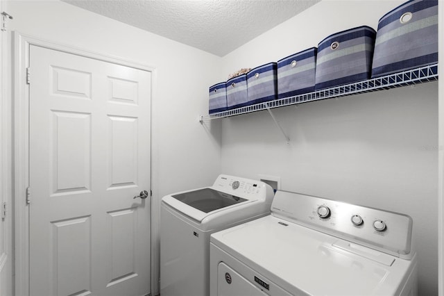 43 Pergola Pl, Ormond Beach, FL 32174 - laundry area with washer and dryer and a textured ceiling