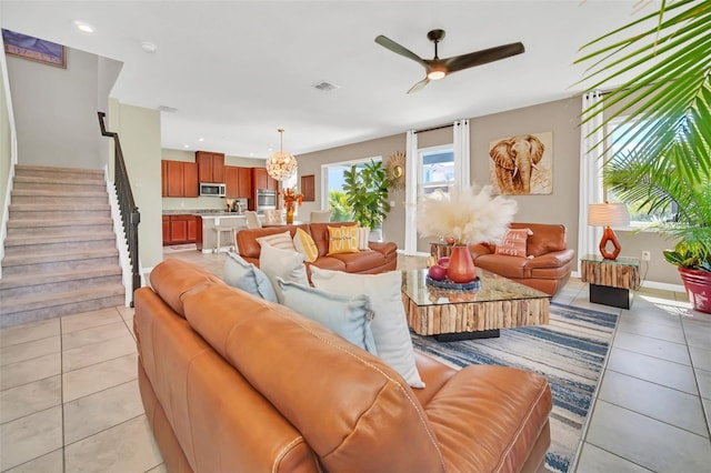 6926 Cucamelon Ct, Windermere, FL 34786 - living area with light tile patterned floors, a ceiling fan, stairway, a chandelier, and recessed lighting
