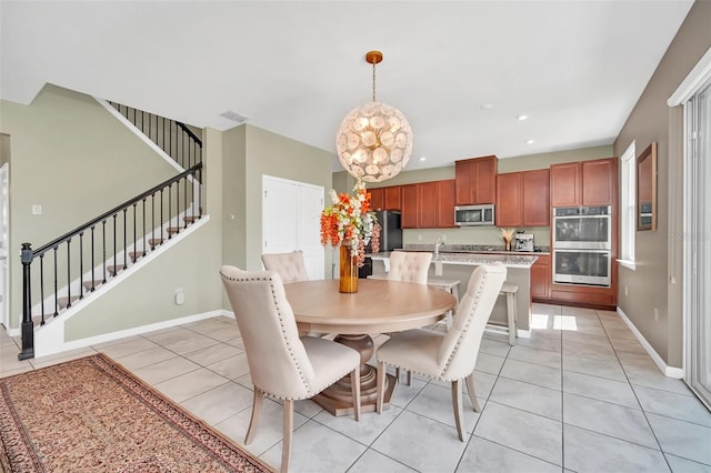 6926 Cucamelon Ct, Windermere, FL 34786 - dining space with stairway, light tile patterned floors, a chandelier, and recessed lighting